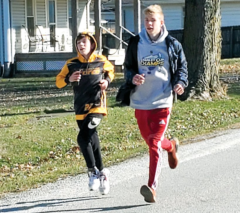 In a spirited race to the finish, Kannon Jonas, left, and Nicholas Harston make their way to the finish line at the third annual First Noelle 5K on Saturday, Dec. 5, in Nokomis.